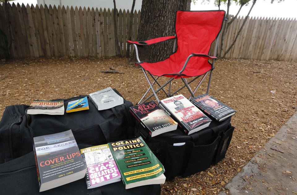 Conspiracy theorist's chair sits empty with conspiracy books laid out in front of it at the top of the infamous "Grassy Knoll" in Dealey Plaza, in Dallas