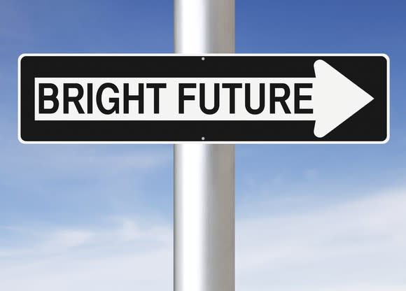 A sign on a pole, fashioned to look like a one-way sign, reads bright future.