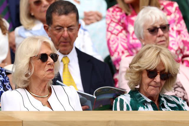 <p>Clive Brunskill/Getty Images</p> Queen Camilla and Annabel Elliot attend day ten of Wimbledon at the All England Lawn Tennis and Croquet Club on July 12, 2023.