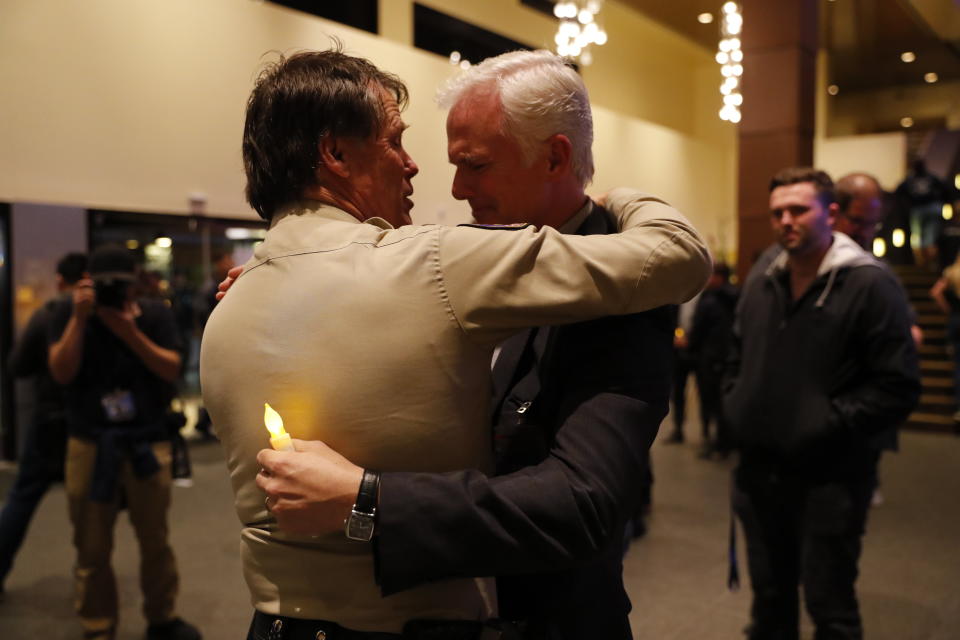 Thousand Oaks Police Chief Tim Hagel, left, hugs Officer Chris Dunn at the vigil. (Photo: Mike Blake / Reuters)