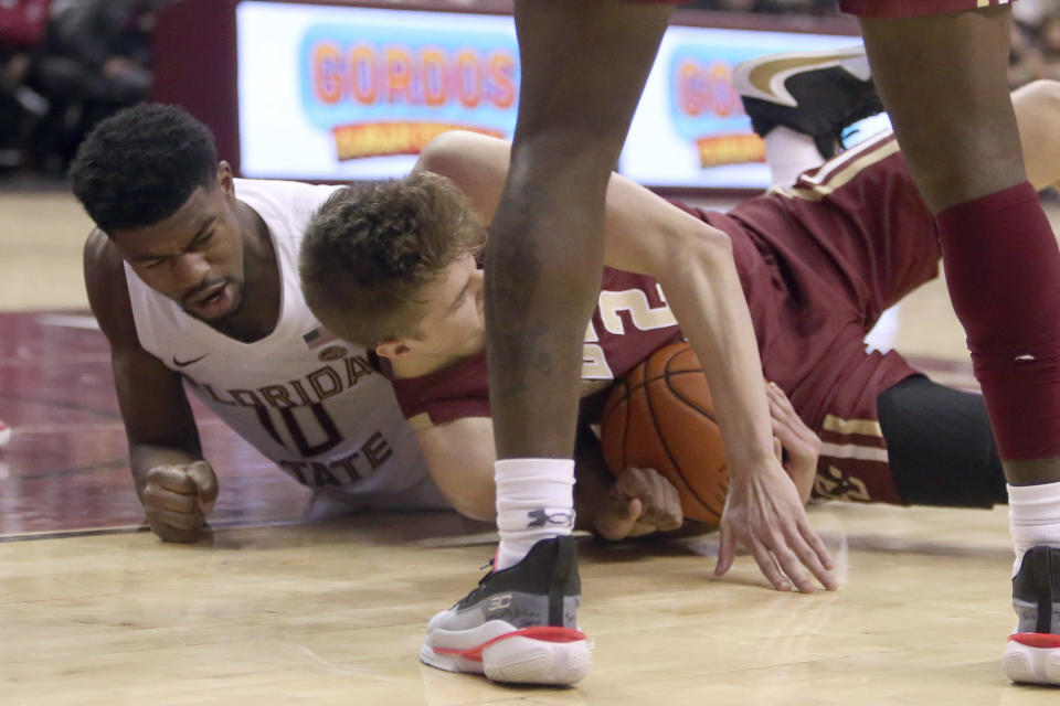 Boston College's Julian Rishwain, right, wrestles with Florida State's Malik Osborne for a loose ball in the second half of an NCAA college basketball game Saturday, March 7 2020, in Tallahassee, Fla. Florida State won 80-62. (AP Photo/Steve Cannon)