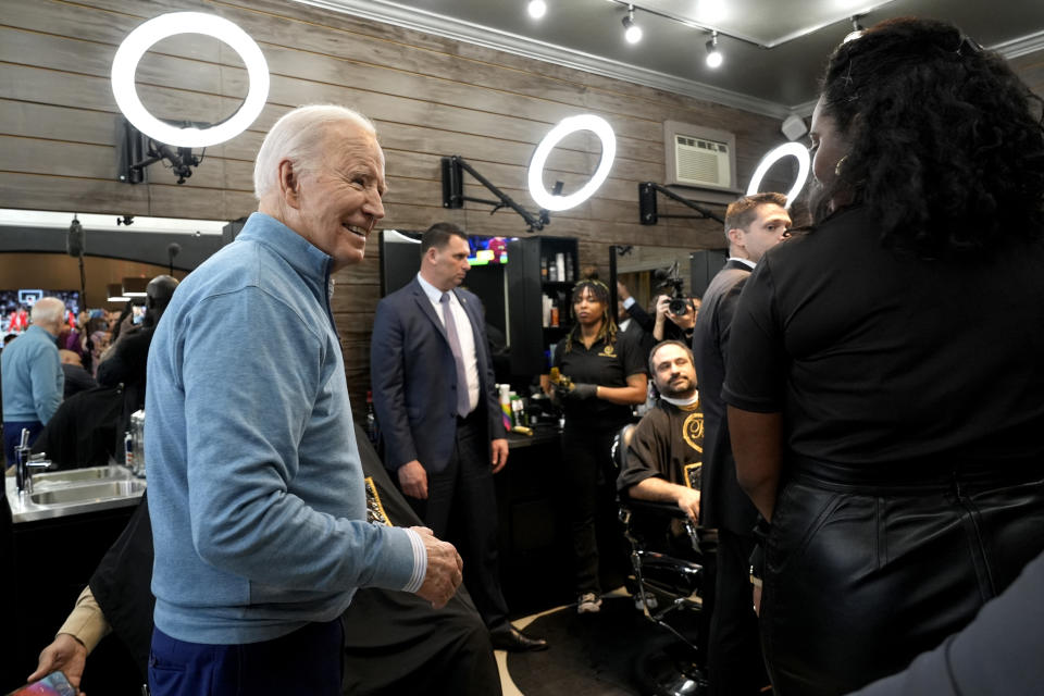 President Joe Biden, left, greets patrons and staff at the Regal Lounge barber shop and spa in Columbia, S.C., Saturday, Jan. 27, 2024. (AP Photo/Jacquelyn Martin)