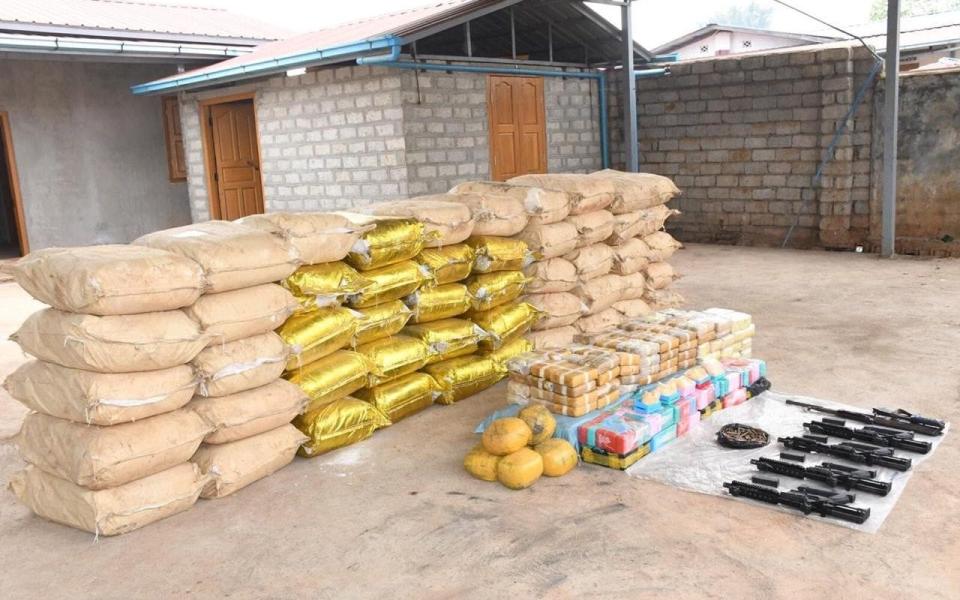 Weapons, ammunition, alongside bags of crystal methamphetamine and meth-laced yaba pills seized by Myanmar police - REUTERS