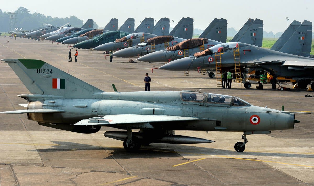 File: An Indian Air Force (IAF) MIG-21 passes near  Sukhoi-30 fighter jets before a  drill for Air Force Day celebrations  (AFP via Getty Images)