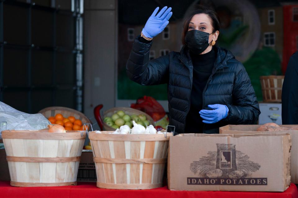 Vice President-elect Kamala Harris waves as she arrives to pack grocery bags for those in need of food while volunteering in the National Day of Service, Jan. 18, 2021, at Martha's Table in southeast Washington, D.C.