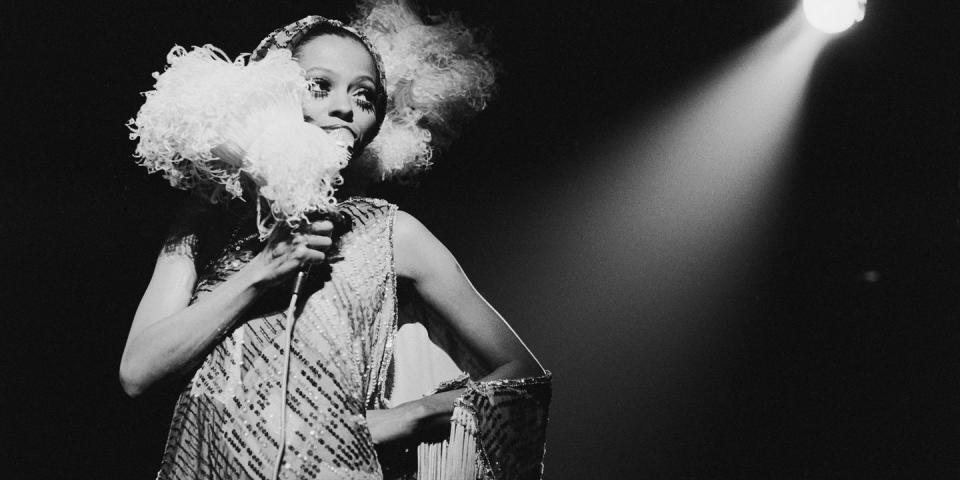 <p>Diana Ross takes the stage in a sequin draped dress with a fringe shawl and feathered hairpiece. In 1976, the singer released her first disco song, "Love Hangover," which promptly <a href="https://www.mprnews.org/story/2016/06/10/diana-ross-went-disco-hit-number-one" rel="nofollow noopener" target="_blank" data-ylk="slk:reached number 1 on the Billboard pop chart;elm:context_link;itc:0;sec:content-canvas" class="link ">reached number 1 on the Billboard pop chart</a>. </p>