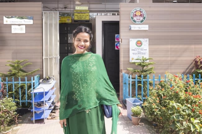 A college student visits a public toilet built by WaterAid, with support from Kimberly-Clark, at a bus stop in Dhaka, Bangladesh.