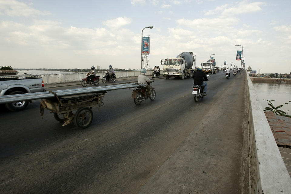 In this photo taken, Feb. 25, 2013, local motorists transport the Chroy Changvar bridge, in Phnom Penh, Cambodia. Constructed in 1966 and rebuilt in 1995 after its destruction at the hands of the Khmer Rouge, the Japanese-Cambodian Friendship Bridge provides a panoramic look at life along both sides of the Tonle Sap River. (AP Photo/Heng Sinith)