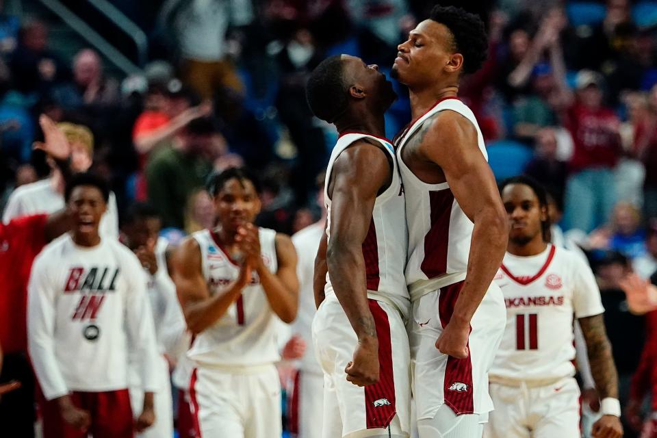 Arkansas guard Davonte Davis, left, and guard Au'Diese Toney celebrate during the second half of the team's college basketball game against New Mexico State in the second round of the NCAA men's tournament Saturday, March 19, 2022, in Buffalo, N.Y. (AP Photo/Frank Franklin II)