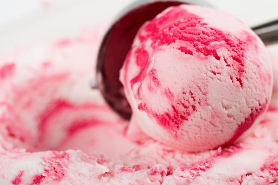 Pink ripple ice cream being scooped with metal scoop