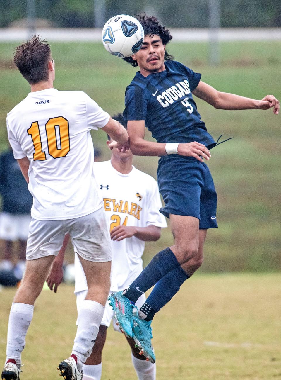 Delcastle Cougars Cristofer Torres-Romero (9) goes up for a header against Newark Yellow Jackets Seth Fuhr (10) during the boys soccer game at Delcastle in Belvedere, Thursday, Oct. 13, 2022. Delcastle won 4-1.