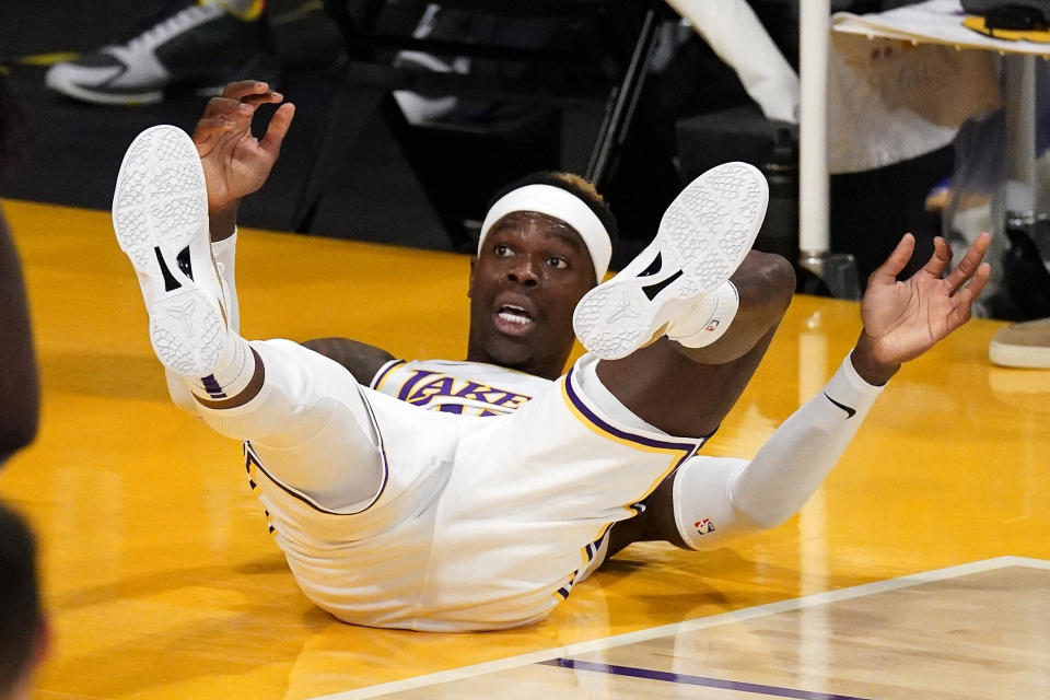 Los Angeles Lakers guard Dennis Schroder falls after being fouled in the act of shooting during the first half of an NBA basketball game against the Golden State Warriors Sunday, Feb. 28, 2021, in Los Angeles. (AP Photo/Mark J. Terrill)