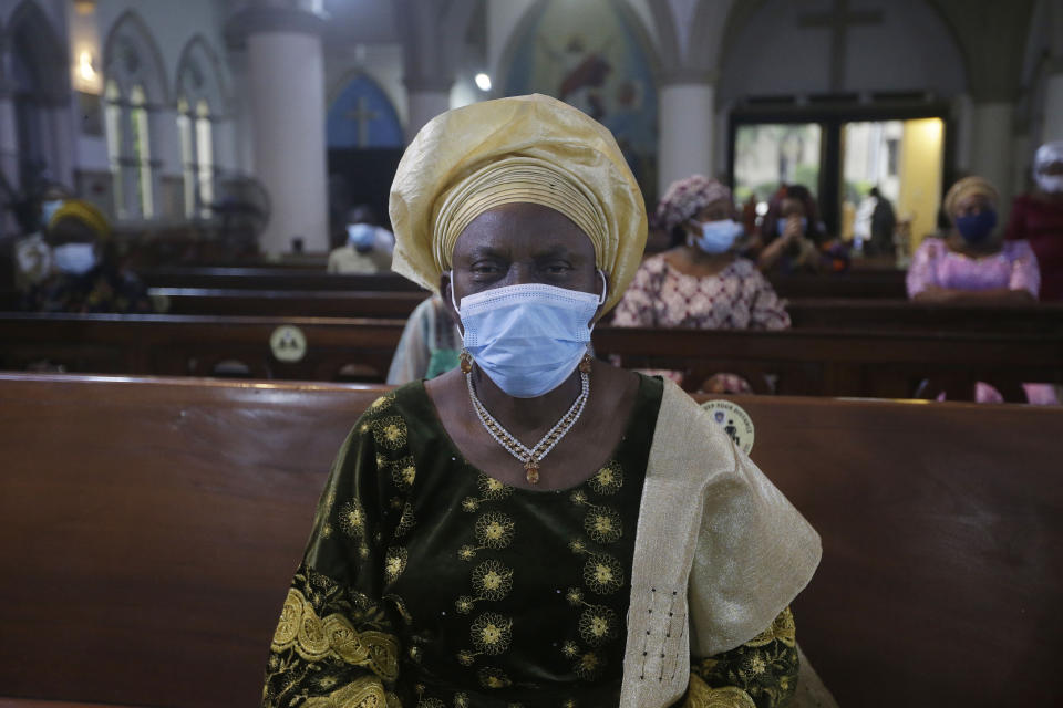 A parishioner wearing face mask to protect against coronavirus, attends a morning Christmas Mass at Holy Cross Cathedral in Lagos, Nigeria, Friday Dec. 25, 2020. Africa's top public health official says another new variant of the coronavirus appears to have emerged in Nigeria, but further investigation is needed. The discovery could add to new alarm in the pandemic after similar variants were announced in recent days in Britain and South Africa and sparked the swift return of travel restrictions. (AP Photo/Sunday Alamba)