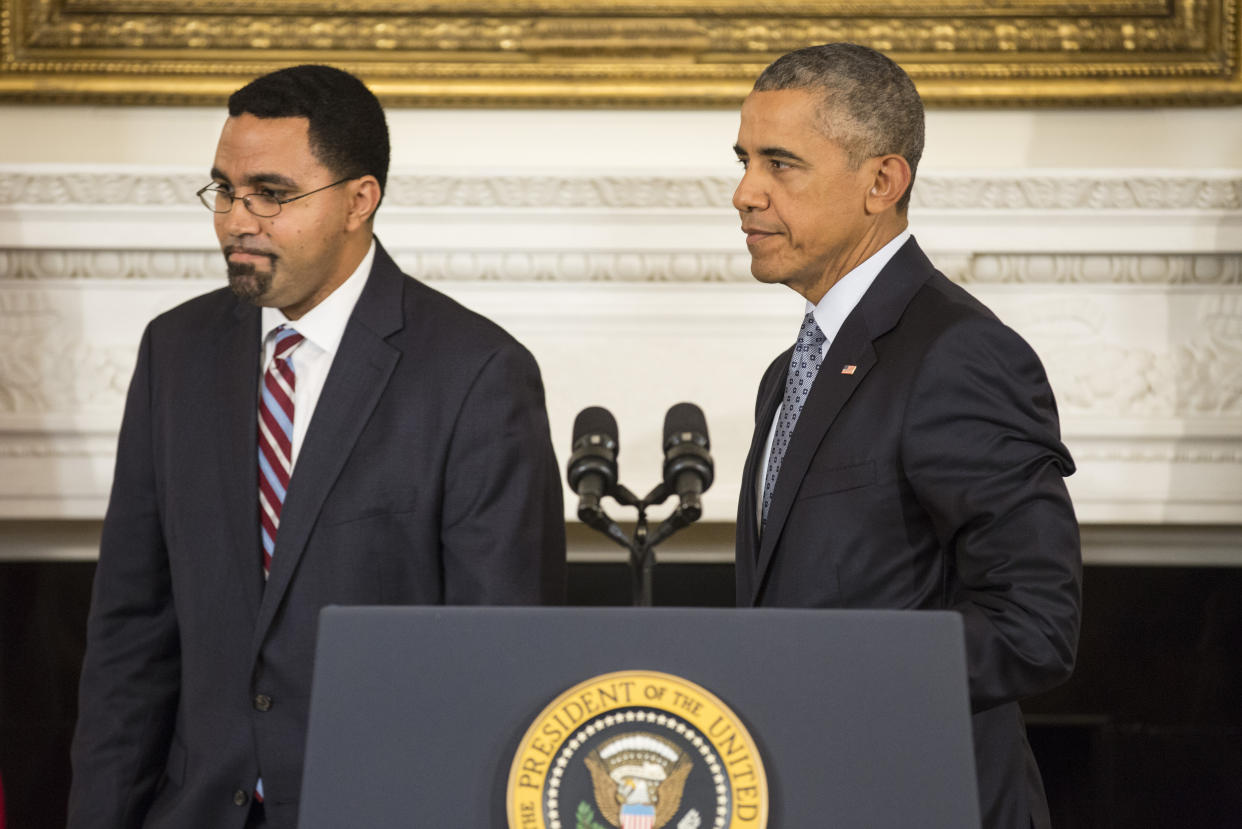 U.S. President Barack Obama walks with John B. King Jr., (L) who he has appointed to be the next U.S. Secretary of Education upon the resignation of current secretary Arne Duncan in the State Dining Room of the White House in Washington October 2, 2015.      REUTERS/Joshua Roberts