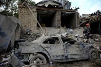 FILE PHOTO: A damaged car is seen at the blast site hit by a rocket during the fighting over the breakaway region of Nagorno-Karabakh in the city of Ganja