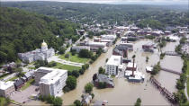 FILE - This image made from drone footage provided by the Vermont Agency of Agriculture, Food and Markets shows flooding in Montpelier, Vt., Tuesday, July 11, 2023. Vermont has become the first state to enact a law requiring fossil fuel companies to pay a share of the damage caused by climate change, Thursday, May 30, 2024 after the state suffered catastrophic summer flooding and damage from other extreme weather. (Vermont Agency of Agriculture, Food and Markets via AP)
