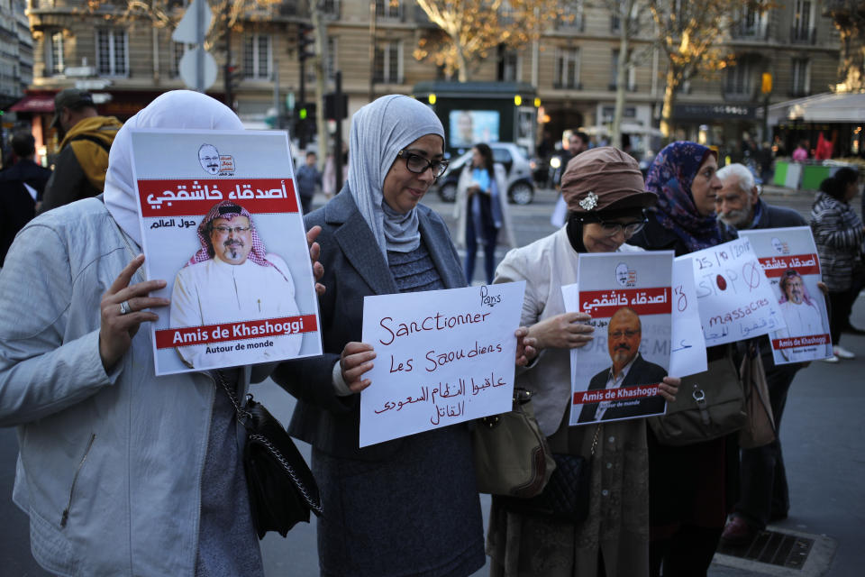 Activists holding portraits reading "Friends of Khashoggi around the world" attend a protest closed to the Saudi Arabia embassy, in Paris, Thursday, Oct. 25, 2018. Saudi prosecutors say the killing of journalist Jamal Khashoggi was planned, state-run media reported Thursday, reflecting yet another change in the shifting Saudi Arabian account of what happened to the writer who was killed by Saudi officials in their Istanbul consulate. (AP Photo/Francois Mori)