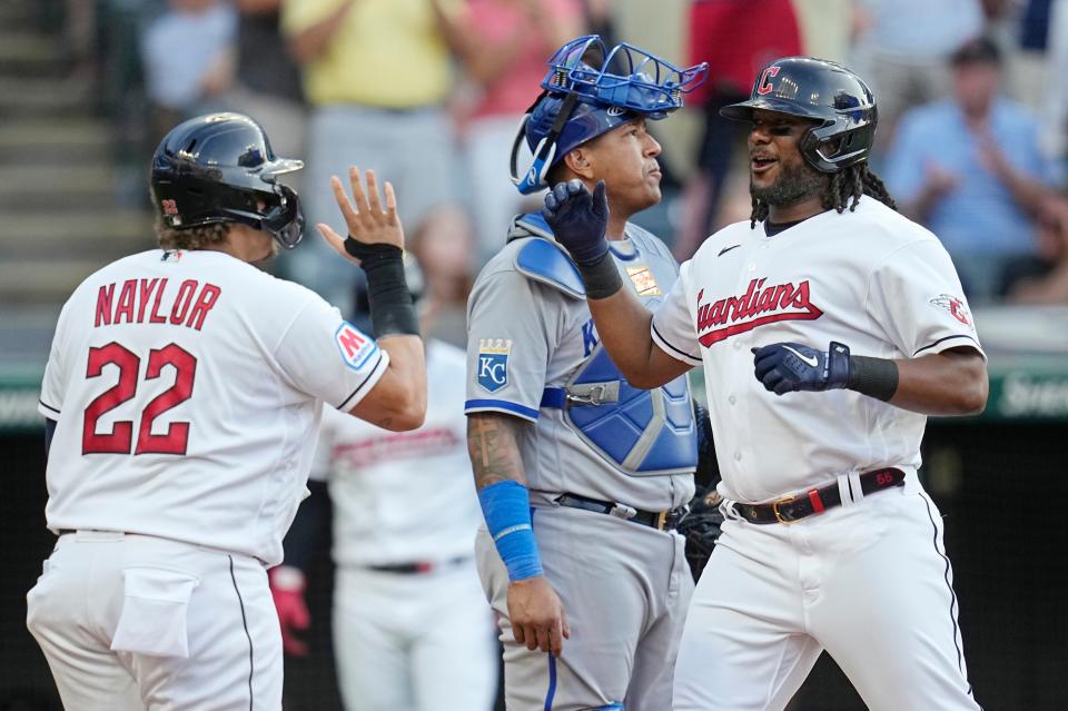 Cleveland Guardians' Josh Bell, right, celebrates his home run with Josh Naylor (22), next to Kansas City Royals catcher Salvador Perez during the fourth inning of a baseball game Friday, July 7, 2023, in Cleveland. (AP Photo/Sue Ogrocki)