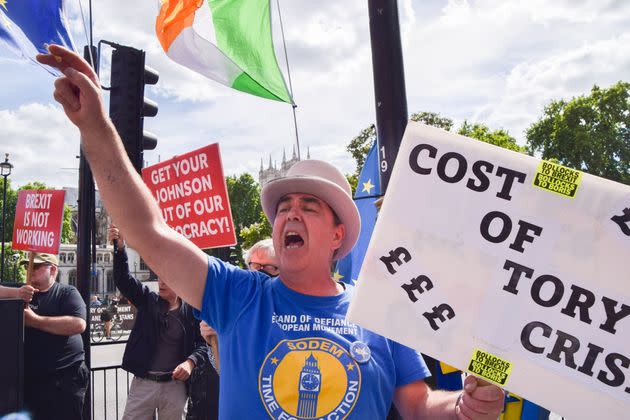 Anti-Brexit activist Steve Bray holds a placard which reads 'Cost of Tory crisis' while shouting slogans during the demonstration. (Photo: SOPA Images via Getty Images)