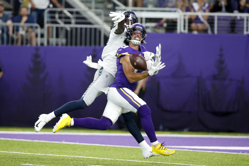 Minnesota Vikings wide receiver Adam Thielen, front, tries to make a reception in front of Seattle Seahawks cornerback Tre Flowers, back, during the first half of an NFL preseason football game, Sunday, Aug. 18, 2019, in Minneapolis. Flowers was called for pass interference on the play. (AP Photo/Bruce Kluckhohn)