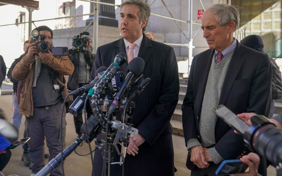 Donald Trump's former lawyer and fixer Michael Cohen, center, speaks to reporters after a second day of testimony before a grand jury - AP