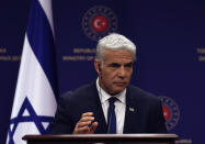 Israeli Foreign Minister Yair Lapid speaks to the media during a joint news conference with Turkish Foreign Minister Mevlut Cavusoglu, in Ankara, Turkey, Thursday, June 23, 2022. Lapid on Thursday thanked Turkish authorities for their cooperation in allegedly foiling attacks against Israeli citizens in Turkey and warned Israel would not "sit idly by " in the face of threats to its citizens from Iran.(AP Photo/Burhan Ozbilici)