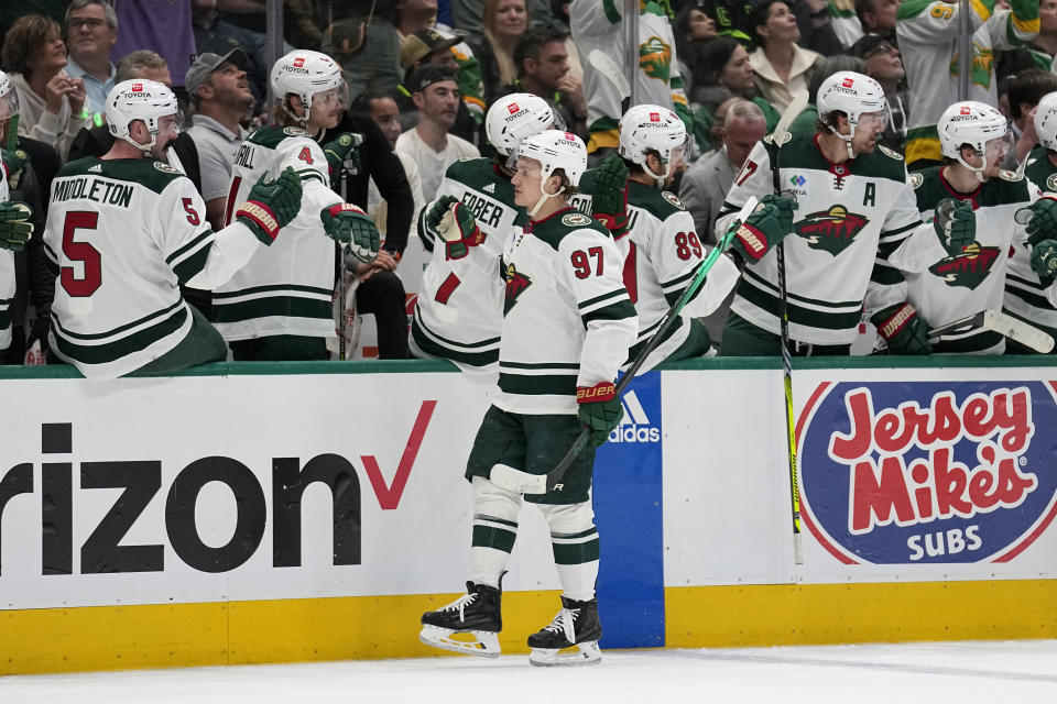 Minnesota Wild left wing Kirill Kaprizov (97) celebrates with the bench after socring against the Dallas Stars during the first period of Game 1 of an NHL hockey Stanley Cup first-round playoff series, Monday, April 17, 2023, in Dallas. (AP Photo/Tony Gutierrez)