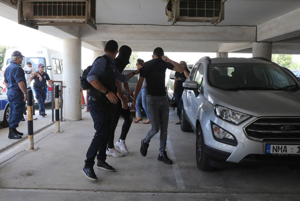 Twelve Israeli tourists, pictured arriving at a Cypriot court, were cleared of raping the girl. (Getty)