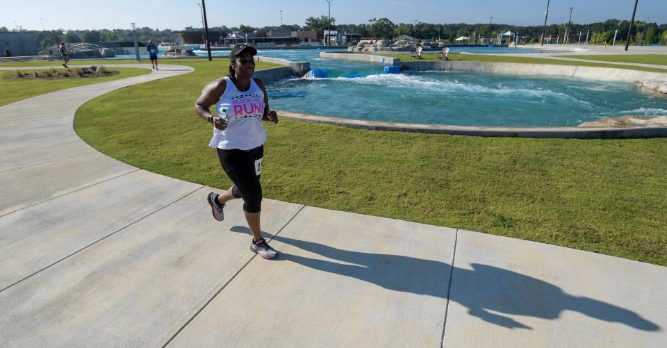 Angela Henderson participates in the Splash 5K Run during the opening weekend at Montgomery Whitewater in Montgomery, Ala., on Saturday July 8, 2023.