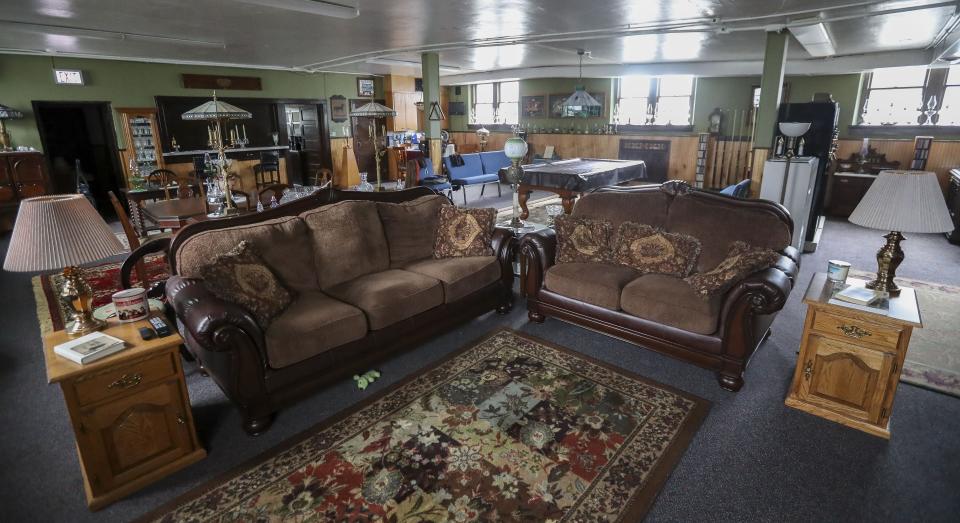 Michael Kennelly's living space is in lower level at the former Grace Baptist Church in Marshfield. It has a more modern feel than the rest of the church, but Kennelly still intersperses museum-quality antiques with more modern pieces.