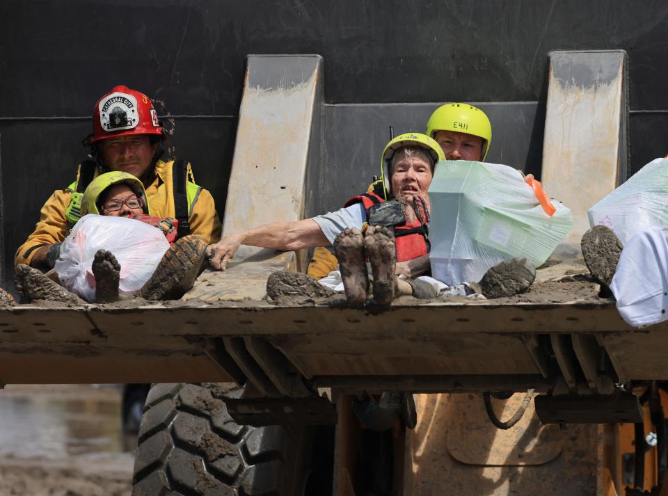 Cathedral city fire department rescues residents in a bulldozer following heavy rains from tropical storm Hilary in Cathedral City, California (AFP/Getty)