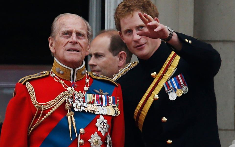  Prince Harry talks to Prince Philip as members of the Royal family appear on the balcony of Buckingham Palace, during the Trooping The Colour parade, in central London in 2014  - AP Photo/Lefteris Pitarakis, File