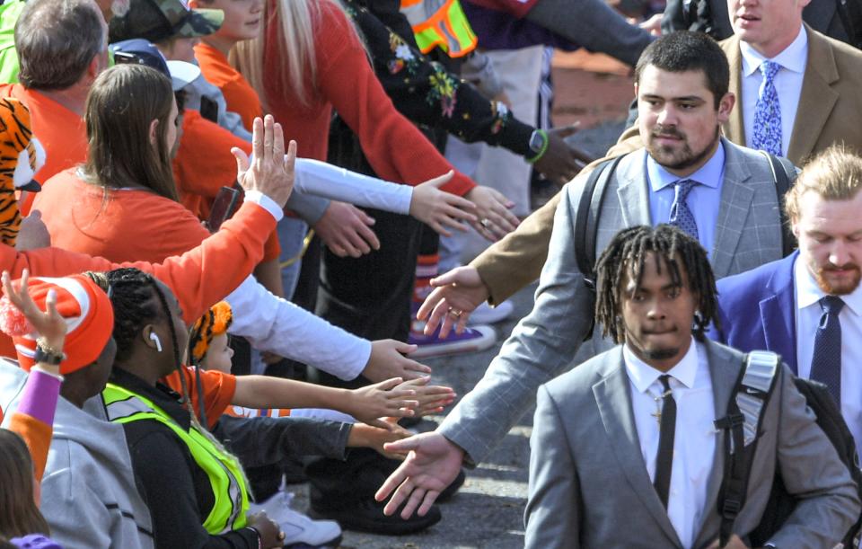 Clemson defensive lineman Bryan Bresee greets fans during Tiger Walk before game with Miami outside Memorial Stadium in Clemson, South Carolina Saturday, Nov. 19, 2022.   