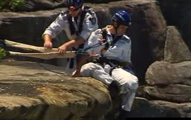 Police Rescue officers prepare to scale down the cliff face. Source: 7 News.