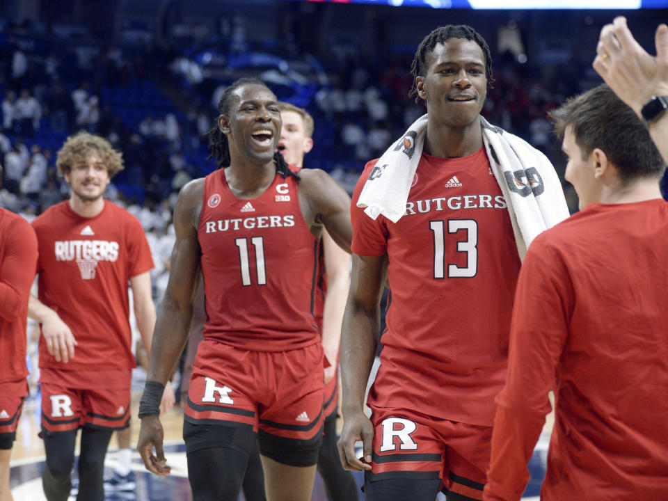 Rutgers' Clifford Omoruyi (11) and Antwone Woolfolk (13) come off the court after defeating Penn State in an NCAA college basketball game, Sunday, Feb. 26, 2023, in State College, Pa. (AP Photo/Gary M. Baranec)