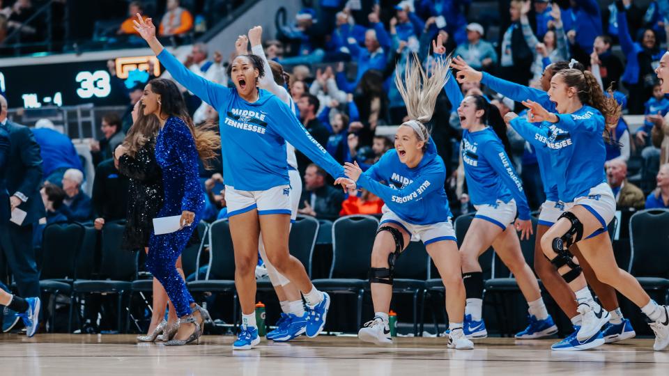 Middle Tennessee State women's basketball players celebrate Wednesday's 73-62 win over Tennessee.