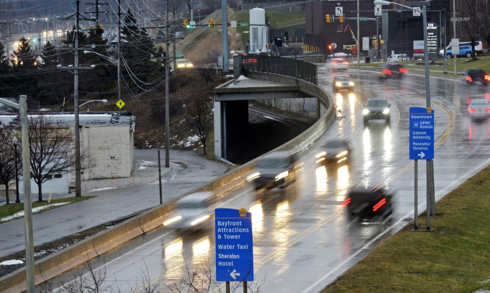 Evening traffic moves along the Bayfront Parkway, looking east, near the intersection of State Street, top right, in Erie on Jan. 24, 2020. PennDOT plans to lower the parkway under State Street, build dual-lane roundabouts at Sassafras and Holland streets and build pedestrian bridges over the parkway.
