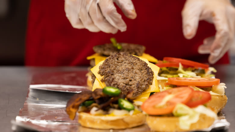 Five Guys employee preparing burger