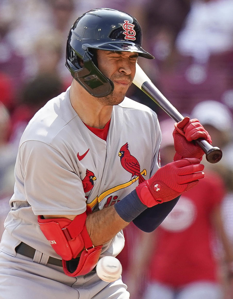 St. Louis Cardinals' Dylan Carlson is hit by a pitch during the eighth inning of a baseball game against the Cincinnati Reds in Cincinnati, Sunday, July 25, 2021. (AP Photo/Bryan Woolston)