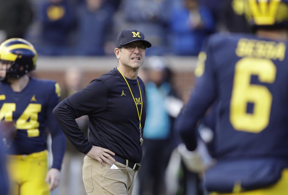 Michigan head coach Jim Harbaugh has a growing list of scholarship offers out to middle-schoolers. (AP Photo)