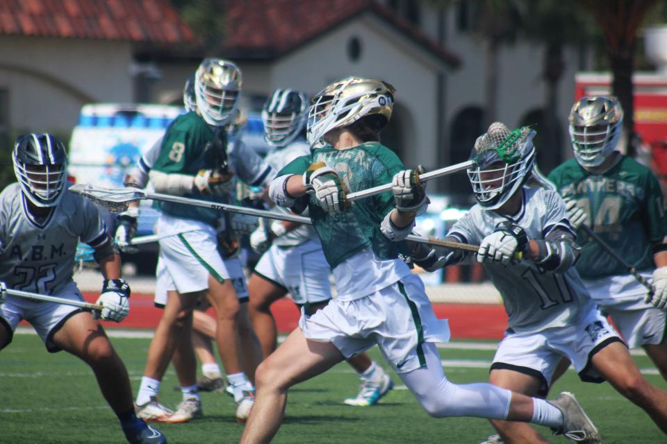 Nease's Jackson Coughlin (10) launches a shot for the first goal against Tallahassee Maclay at the Rivalry on the River lacrosse tournament.