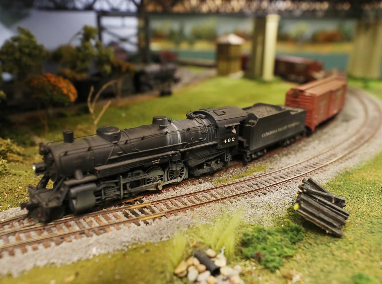 A train runs along the track at the Cuyahoga Valley Terminal Model Railroad Club. The club has built a historical model of the Valley Line set in the 1950s that includes real places in the Akron and Cleveland area.