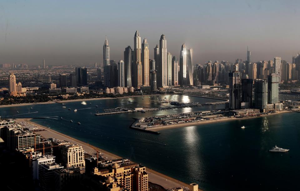 Luxury towers that dominate the skyline in the Dubai Marina district, center, and the new Dubai Harbor development, right, are seen from the observation deck of "The View at The Palm Jumeirah" in Dubai, United Arab Emirates, Tuesday, April 6, 2021. A global body focused on fighting money laundering on Friday, March 4, 2022, placed the United Arab Emirates on its so-called "gray list" over concerns that the global trade hub isn't doing enough to stop criminals and militants from hiding wealth there. Real estate is one sector analysts say is ripe for hiding those funds.