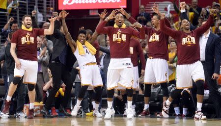 May 4, 2016; Cleveland, OH, USA; The Cleveland Cavaliers bench, including forward Kevin Love (0), guard Iman Shumpert (4), guard J.R. Smith (5), and center Tristan Thompson (13) celebrate Cleveland Cavaliers guard Mo Williams' (52) three-pointer during the fourth quarter in game two of the second round of the NBA Playoffs at Quicken Loans Arena. Mandatory Credit: Ken Blaze-USA TODAY Sports