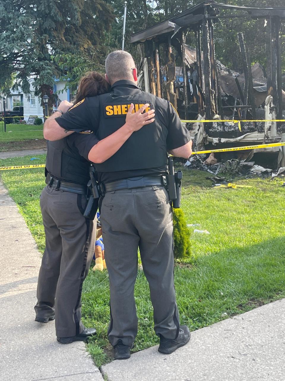 Investigators returned to the scene of a mobile home park in Clark County the day after a Clark County deputy was shot and later died from his injuries. A memorial outside the house has started to grow with two deputies arriving at the scene and placing flowers outside the house. (Gabrielle Enright/Staff)