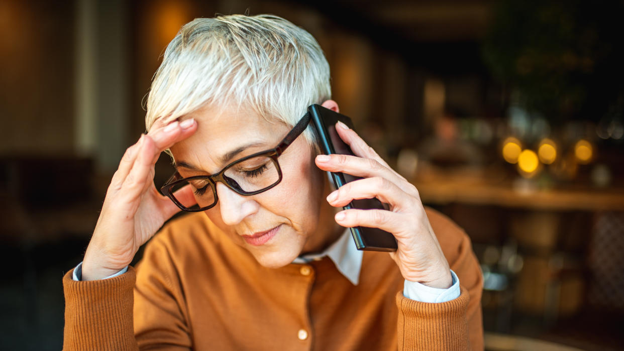 Stressful businesswoman talking on the mobile phone.