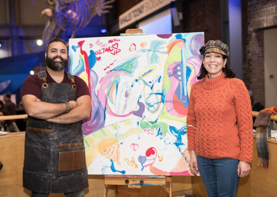 Executive Director, New Bedford Art Museum/Artworks! Suzanne de Vegh, right, with artist Devin Nived Mclaughlin, left, who takes his pantings on the road such as at the "Love Letters for New Bedford" event at the Whaling Museum.