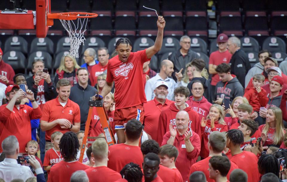 The crowd cheers for Bradley's Zek Montgomery as he cuts down a piece of net after the Braves' 73-61 defeat of Drake  on Sunday, Feb. 26, 2023 at Carver Arena.