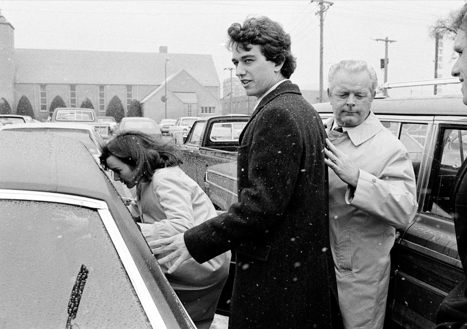 FILE - In this March 17, 1984 file photo, Robert Kennedy Jr. and his wife, Emily, get into a car as they are escorted by private investigator Don Wiley outside the courthouse in Rapid City, S.D. Kennedy received a suspended sentence and two years probation on his guilty plea to a charge of heroin possession. (AP Photo/Mark Elias)