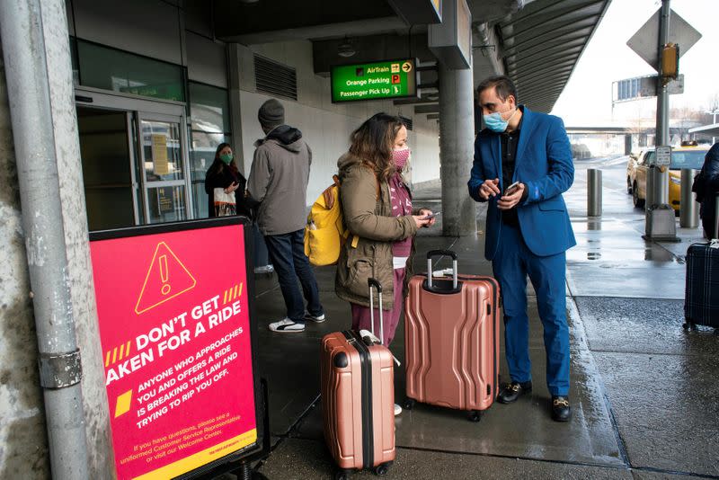 Passengers arrive on a flight from London amid new restrictions to prevent the spread of coronavirus disease (COVID-19) at JFK International Airport in New York City